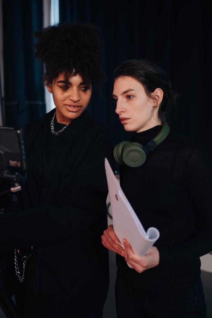 Two women in conversation on a film set, enhancing production collaboration.